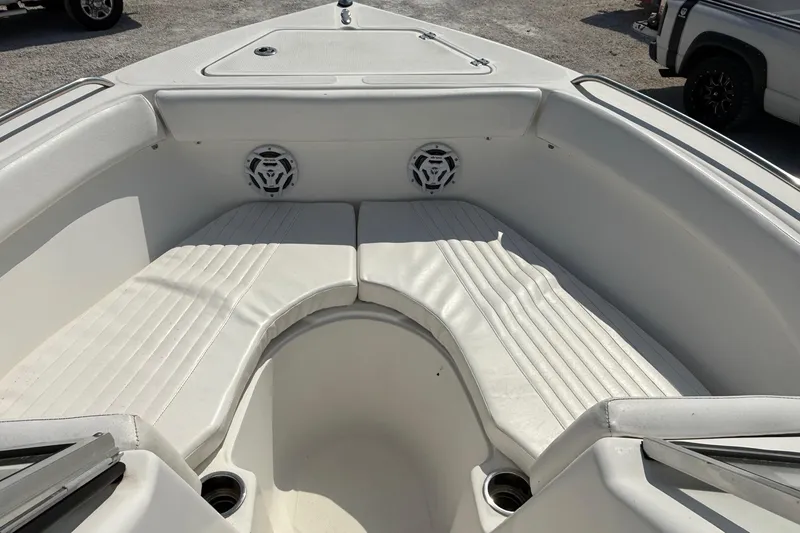 Slide: The Image of 2012 Sea Fox 216 Dual Console boat interior with white cushioned seating and speakers. - 19