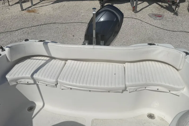 Slide: The Image of 2012 Sea Fox 216 Dual Console boat with white cushioned seating and outboard motor. - 20