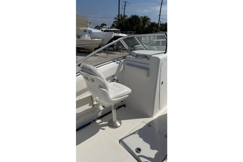 Slide: The Image of 2012 Sea Fox 216 Dual Console boat interior with white seating and windshield. - 21