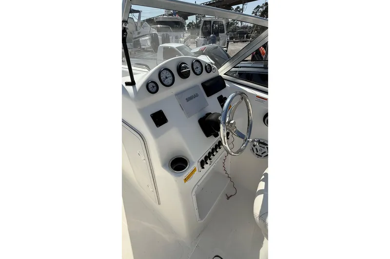 Slide: The Image of 2012 Sea Fox 216 Dual Console boat dashboard with steering wheel and gauges. - 23