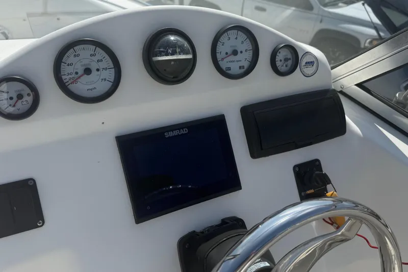 Slide: The Image of Dashboard of a 2012 Sea Fox 216 Dual Console boat with gauges and controls. - 24