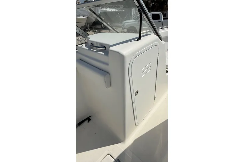 Slide: The Image of 2012 Sea Fox 216 Dual Console boat interior with storage compartment and windshield. - 27