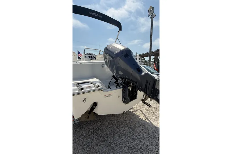 Slide: The Image of 2012 Sea Fox 216 Dual Console boat with outboard motor, parked on gravel. - 4