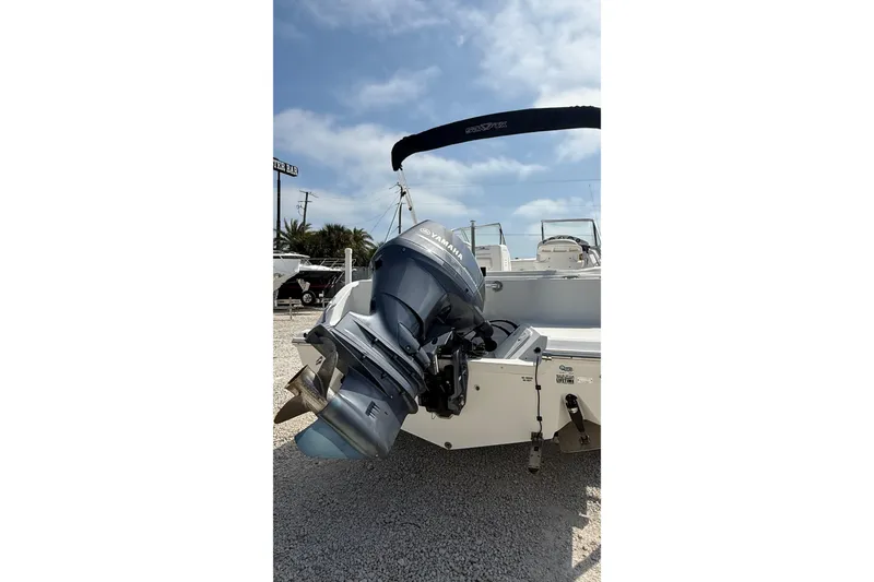 Slide: The Image of 2012 Sea Fox 216 Dual Console boat with Yamaha outboard motor in a sunny marina. - 6