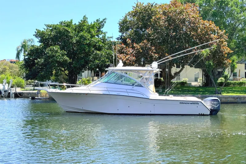 The Image of 2008 Grady-White Express 360 boat on calm water, surrounded by lush greenery. - 0