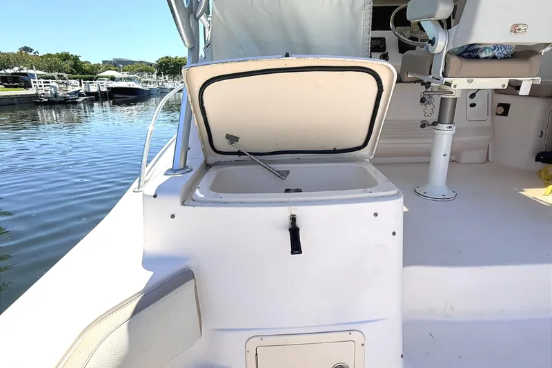 Slide: The Image of 2008 Grady-White Express 360 boat interior with open storage compartment by the water. - 10