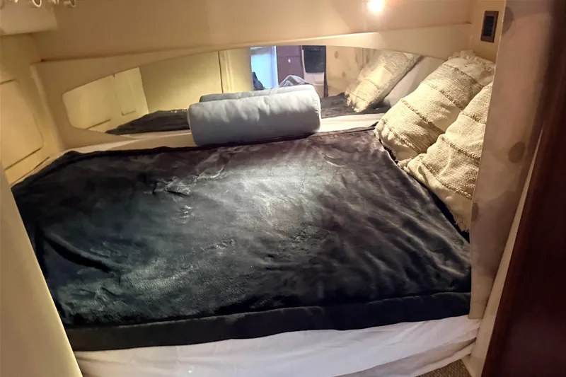 Slide: The Image of Cozy cabin interior of 2008 Grady-White Express 360 with plush bedding and ambient lighting. - 18