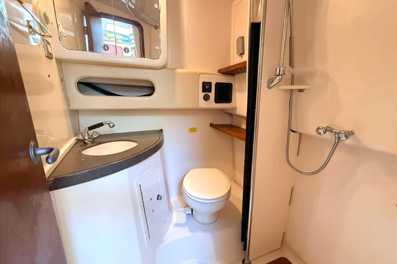 Slide: The Image of 2008 Grady-White Express 360 boat bathroom with sink, toilet, and shower. - 19