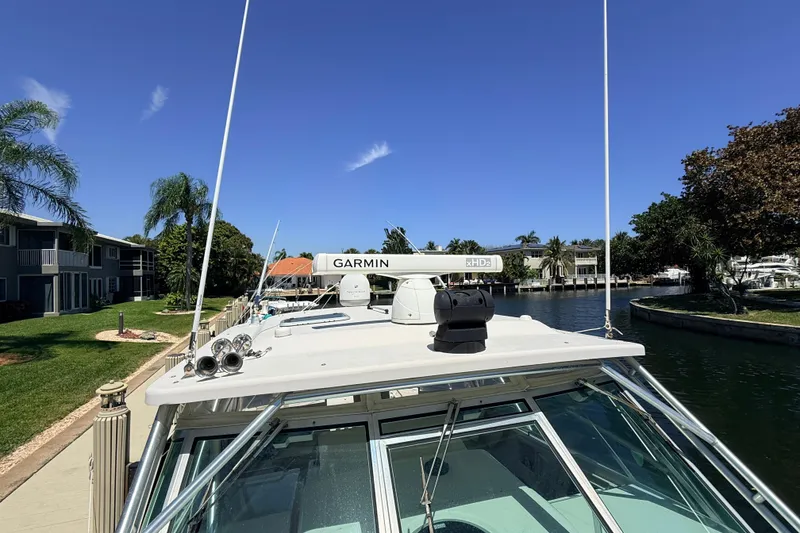 Slide: The Image of 2008 Grady-White Express 360 boat with Garmin radar, docked in a scenic canal. - 23