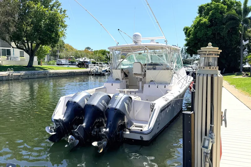 Slide: The Image of 2008 Grady-White Express 360 boat docked with triple Yamaha outboard engines. - 4