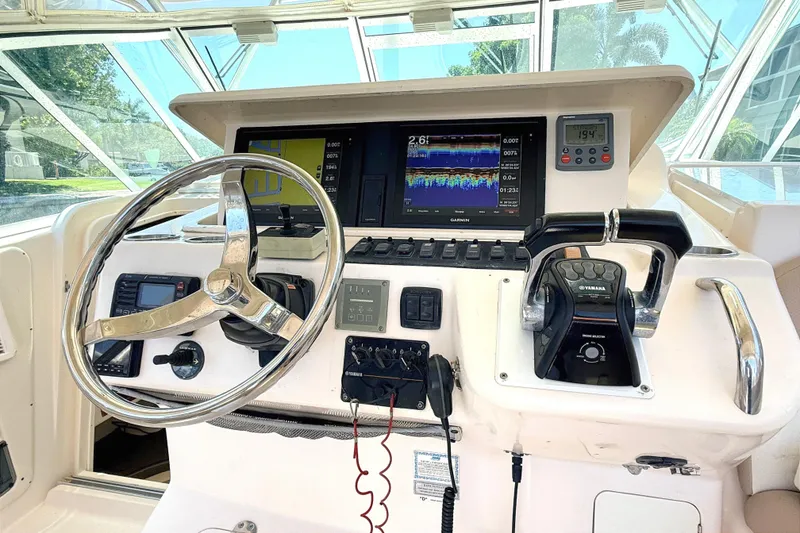 Slide: The Image of 2008 Grady-White Express 360 helm with steering wheel, Garmin display, and Yamaha controls. - 6