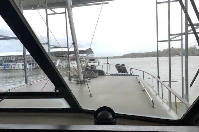 Slide: The Image of 1976 Hatteras 43 Double Cabin yacht view from the helm, docked at a marina. - 14