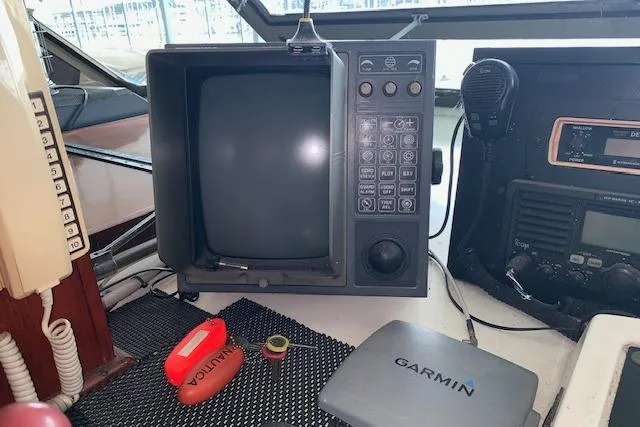 Slide: The Image of 1976 Hatteras 43 Double Cabin helm with vintage electronics and Garmin device. - 15