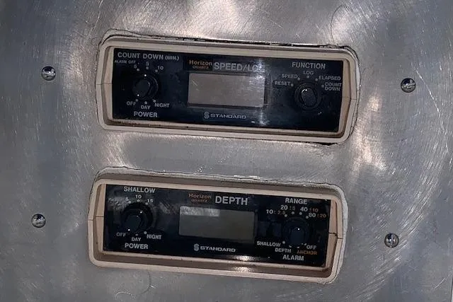 Slide: The Image of Control panel of a 1976 Hatteras 43 Double Cabin boat, featuring speed and depth gauges. - 20