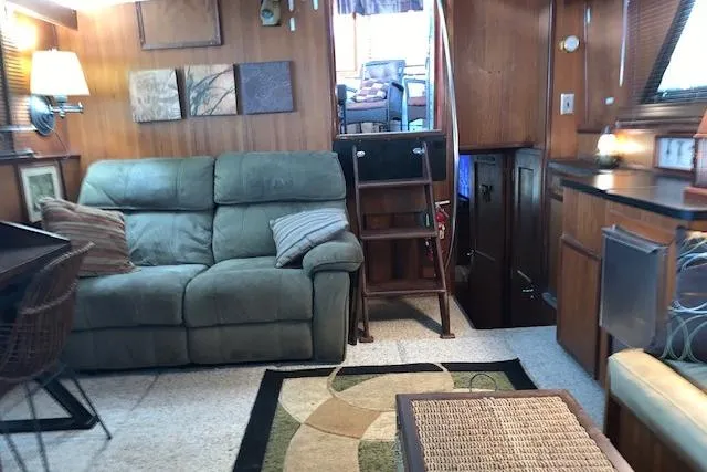 Slide: The Image of Cozy interior of 1976 Hatteras 43 Double Cabin with sofa and wooden decor. - 25