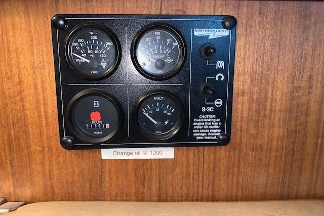 Slide: The Image of Control panel of a 1976 Hatteras 43 Double Cabin boat with gauges and oil change reminder. - 31