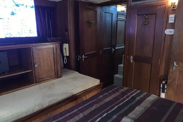 Slide: The Image of 1976 Hatteras 43 Double Cabin interior with wood paneling and cozy furnishings. - 38