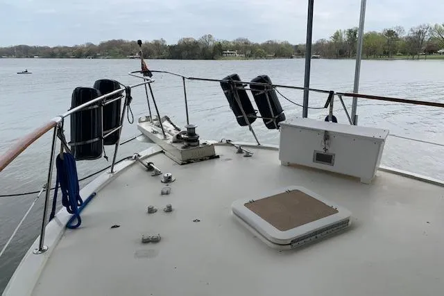 Slide: The Image of 1976 Hatteras 43 Double Cabin yacht deck overlooking calm lake waters. - 4