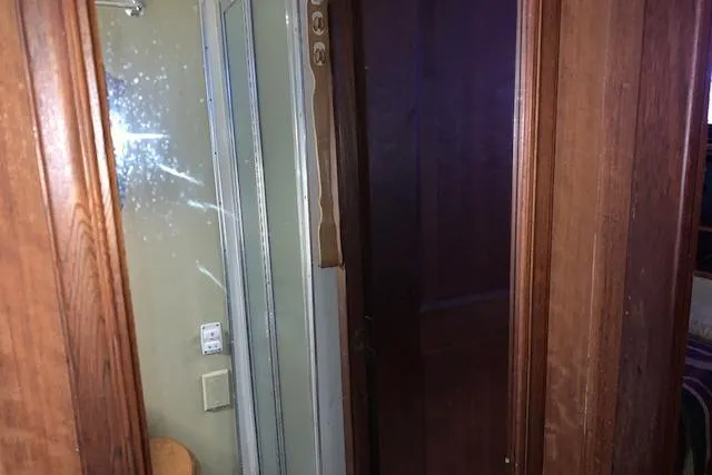 Slide: The Image of Interior view of a 1976 Hatteras 43 Double Cabin with wooden paneling and a mirror. - 41