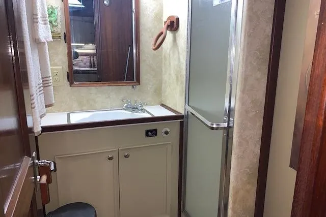 Slide: The Image of Bathroom interior of 1976 Hatteras 43 Double Cabin yacht with sink and shower. - 43