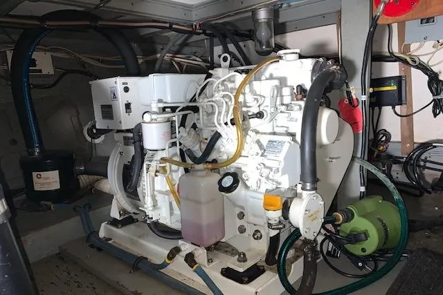 Slide: The Image of Engine room of 1976 Hatteras 43 Double Cabin with visible machinery and components. - 46