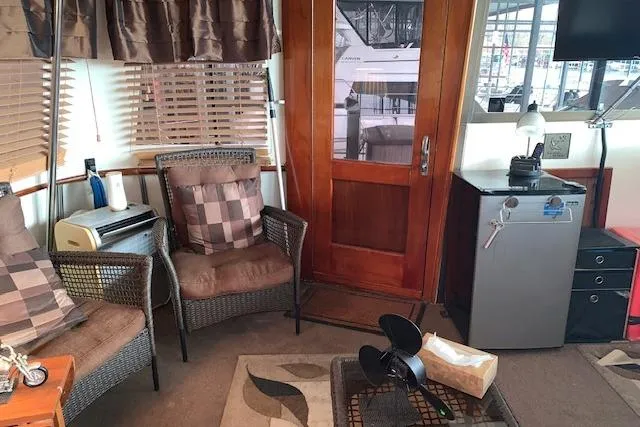 Slide: The Image of Interior of 1976 Hatteras 43 Double Cabin with wicker chairs and wooden accents. - 8