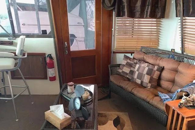 Slide: The Image of Interior of 1976 Hatteras 43 Double Cabin with cozy seating and nautical decor. - 9