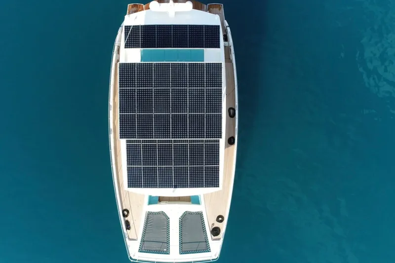 The Image of Aerial view of 2018 Serenity 64 yacht with solar panels on blue water. - 0