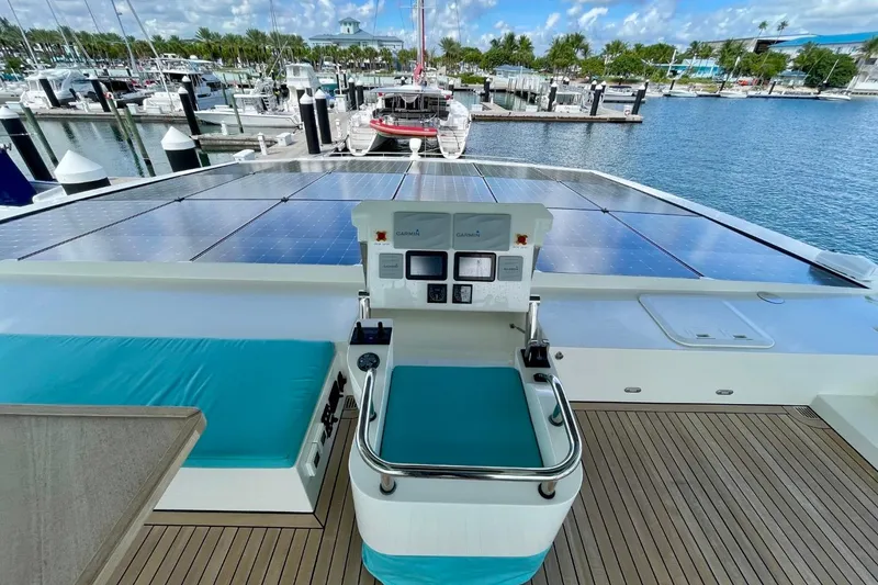 Slide: The Image of Luxurious Serenity 64 yacht deck with solar panels, marina view, and modern controls, 2018 model. - 15