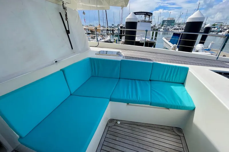 Slide: The Image of Turquoise seating area on 2018 Serenity 64 yacht, docked at marina. - 18