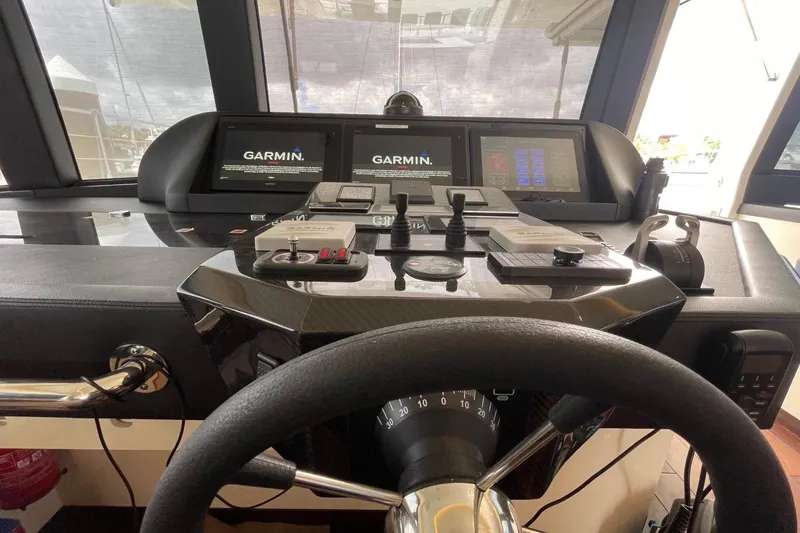Slide: The Image of Cockpit of 2018 Serenity 64 yacht with Garmin navigation displays and controls. - 24