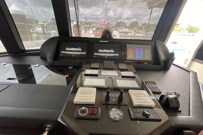 Slide: The Image of Cockpit of 2018 Serenity 64 yacht with Garmin navigation displays and control panels. - 25