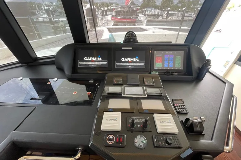 Slide: The Image of Cockpit of 2018 Serenity 64 yacht with Garmin navigation displays and control panels. - 26
