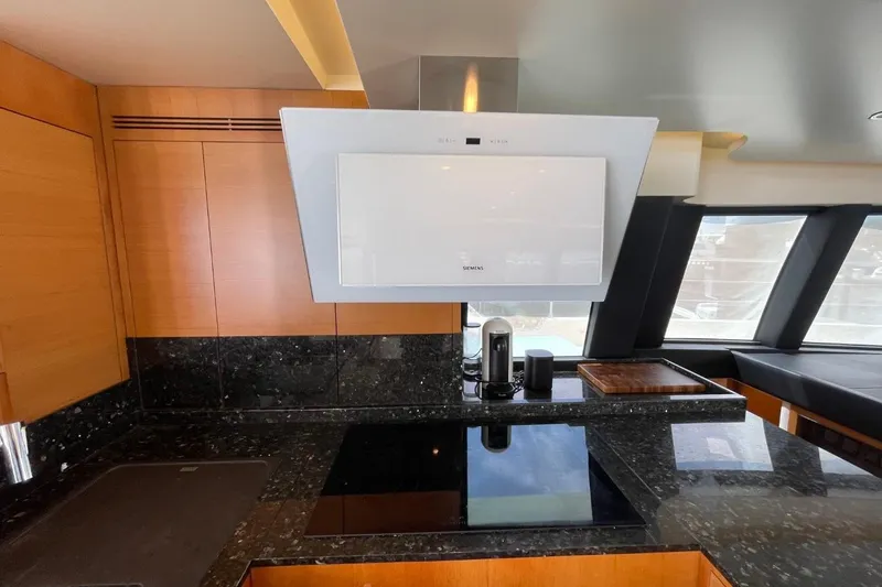 Slide: The Image of Modern kitchen interior on 2018 Serenity 64 yacht with sleek appliances and granite countertops. - 29