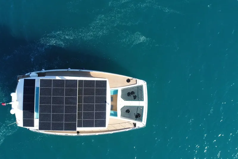 Slide: The Image of Aerial view of 2018 Serenity 64 yacht with solar panels on blue ocean. - 3