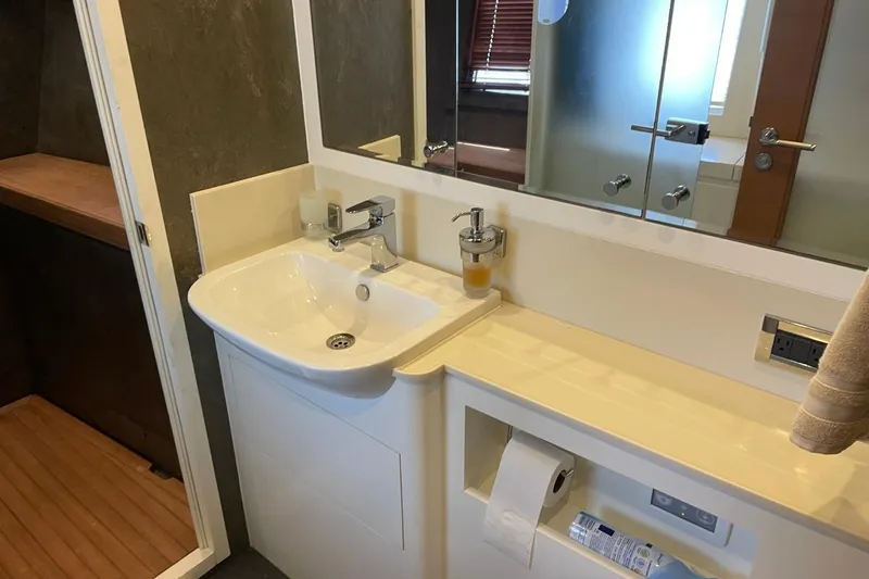 Slide: The Image of Modern bathroom sink with mirror and storage in Serenity 64 yacht, 2018 model. - 36