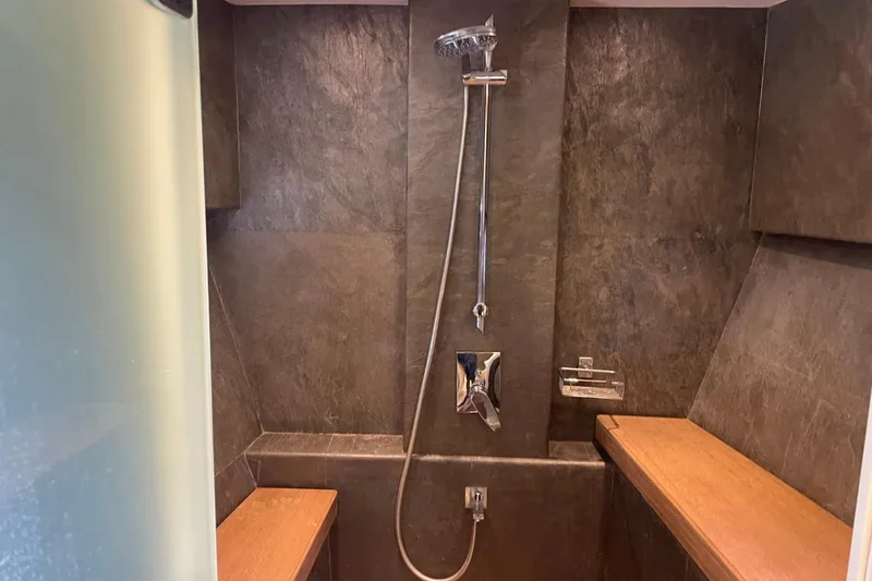 Slide: The Image of Luxurious shower area in 2018 Serenity 64 yacht, featuring sleek design and wooden accents. - 37