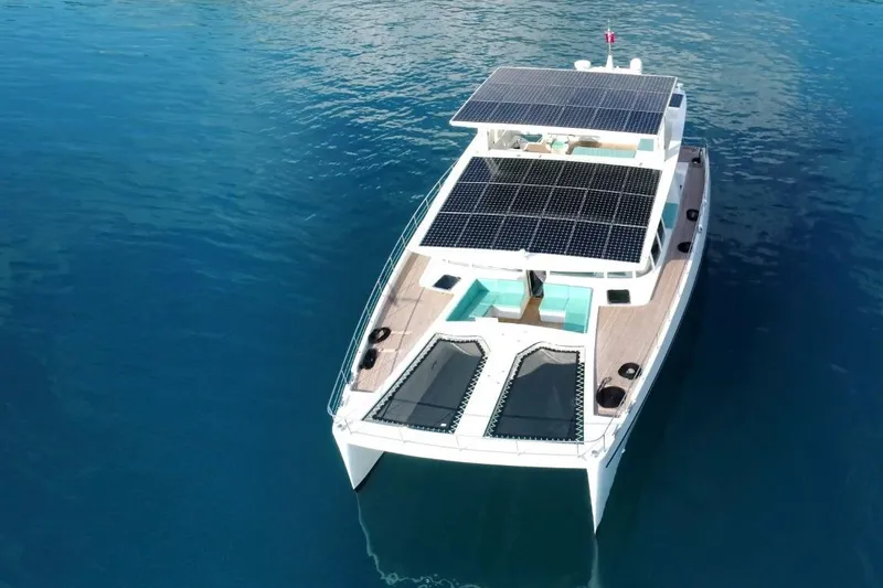 Slide: The Image of Solar-powered Serenity 64 yacht from 2018, cruising on clear blue waters. - 4