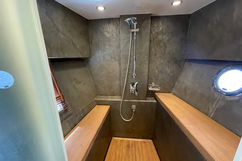 Slide: The Image of Luxurious shower area in 2018 Serenity 64 yacht with modern fixtures and wooden accents. - 42
