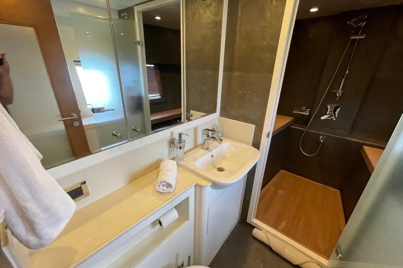 Slide: The Image of Modern bathroom in 2018 Serenity 64 yacht with sleek shower and vanity area. - 60