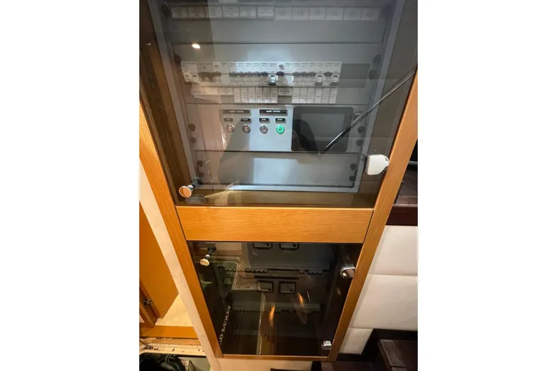 Slide: The Image of Electrical control panel in a Serenity 64 yacht, 2018 model, with glass door enclosure. - 62
