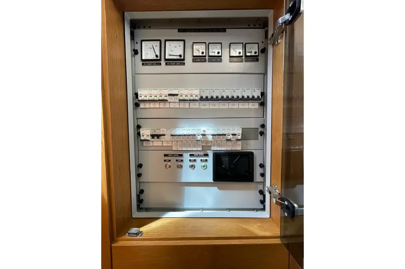 Slide: The Image of Electrical control panel inside a Serenity 64 yacht, model year 2018. - 64