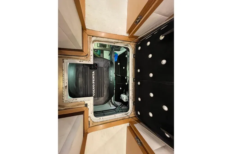 Slide: The Image of Engine compartment of a 2018 Serenity 64 yacht featuring a Volvo Penta D3-200 engine. - 66
