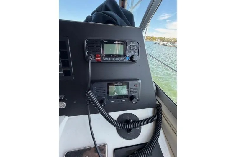 Slide: The Image of Control panel of a 1989 Sea Ray 460 Express Cruiser with communication devices. - 12