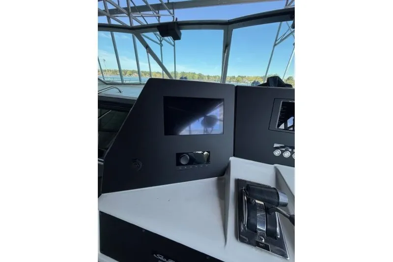 Slide: The Image of Control panel of a 1989 Sea Ray 460 Express Cruiser with throttle and display. - 14