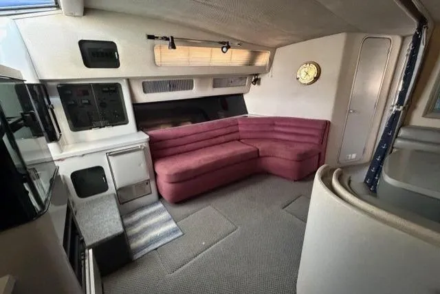 Slide: The Image of Interior of 1989 Sea Ray 460 Express Cruiser with pink seating and nautical decor. - 19