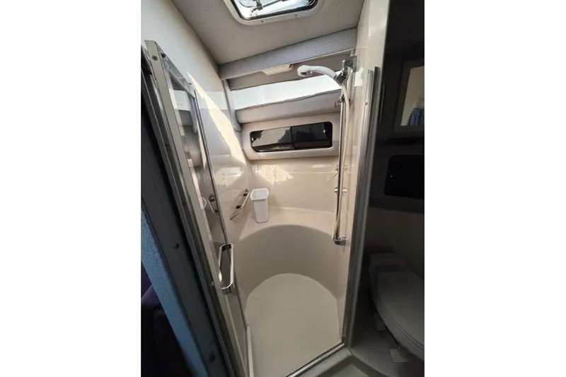 Slide: The Image of 1989 Sea Ray 460 Express Cruiser bathroom with shower and skylight. - 24