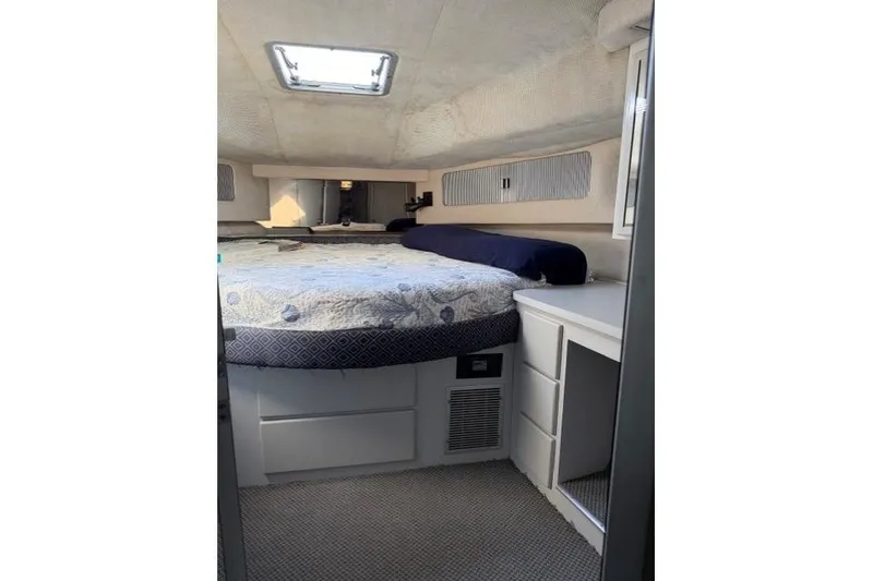 Slide: The Image of Interior cabin of 1989 Sea Ray 460 Express Cruiser with bed and storage. - 26