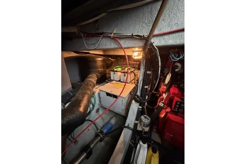 Slide: The Image of Engine room of 1989 Sea Ray 460 Express Cruiser with wiring and components visible. - 29