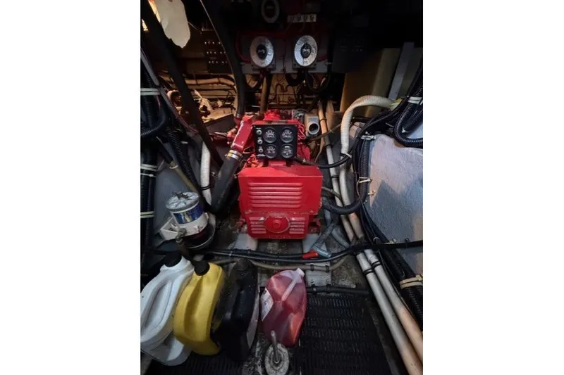 Slide: The Image of Engine room of 1989 Sea Ray 460 Express Cruiser with red machinery and gauges. - 30